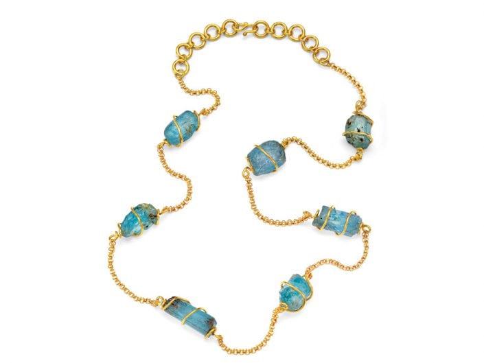 Raw aquamarine gmenstones encased in handmade, 22k gold cages joined by a 22k gold chain